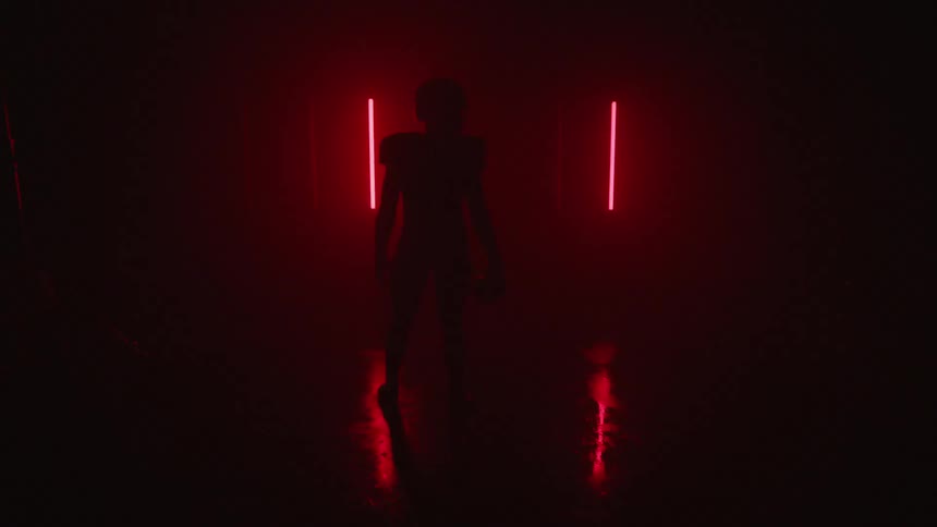 A football player stands in a room with flashing lights