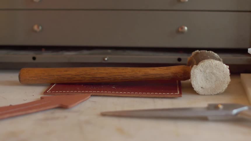 A wooden hammer rests on a countertop
