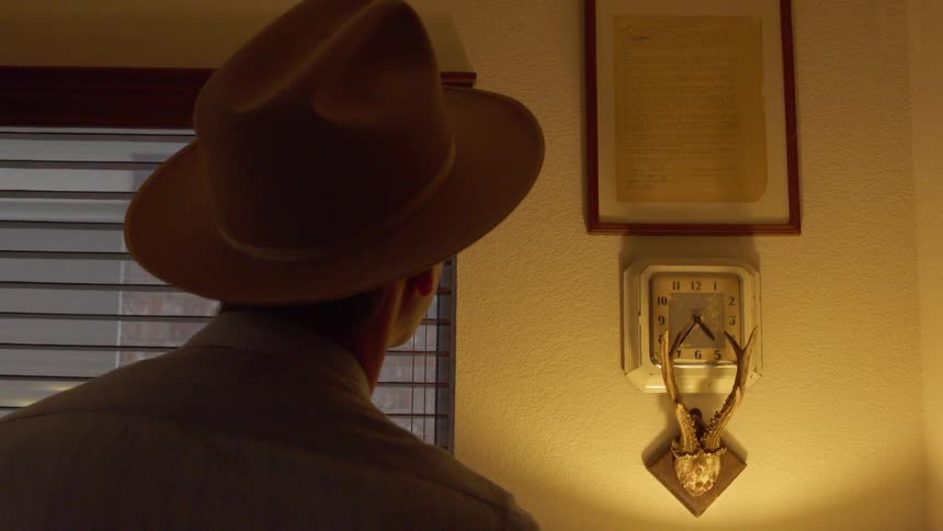 A man looks at a plaque on the wall