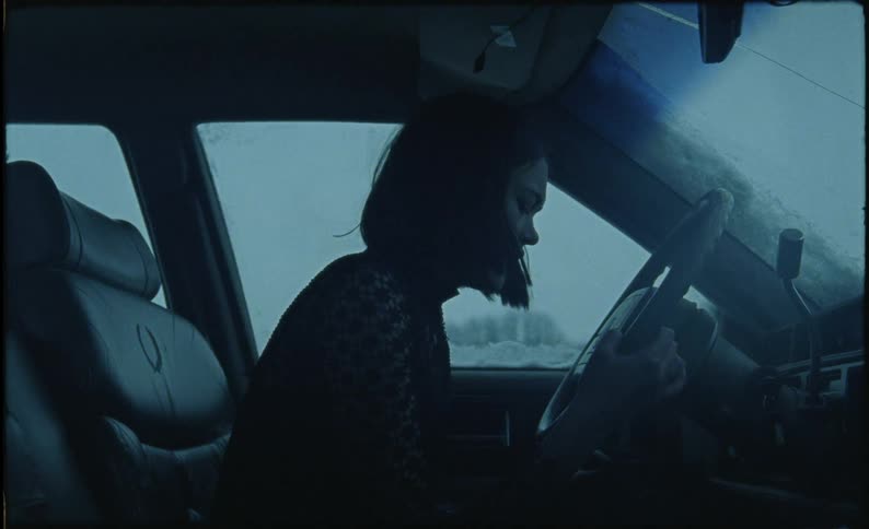 A woman is sobbing in the car