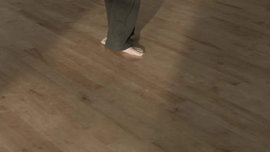 A man dances in a studio alone during the day