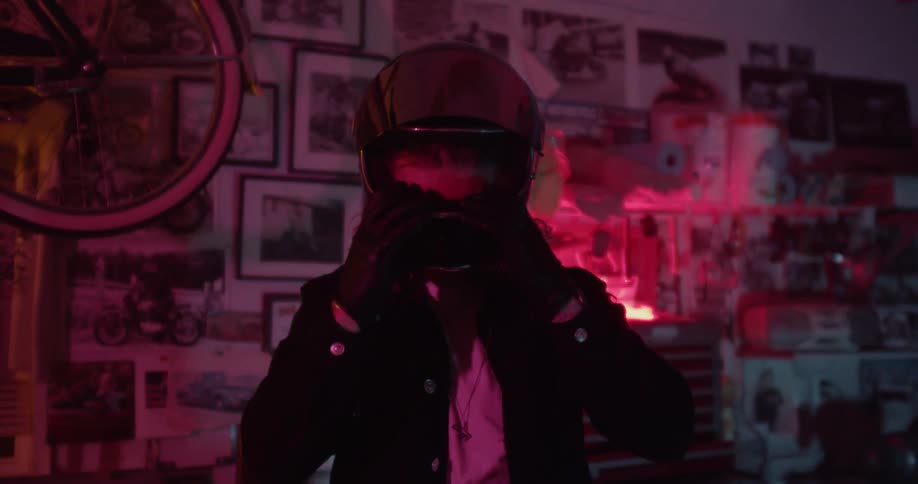 A man removes his motorcycle helmet