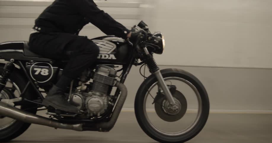 The motorcycle rides fast in the tunnel