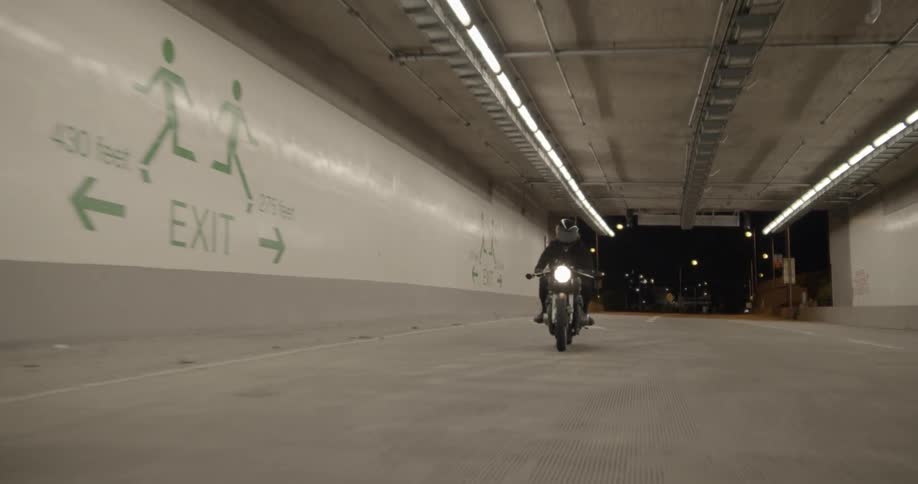 The motorcycle races through the tunnel