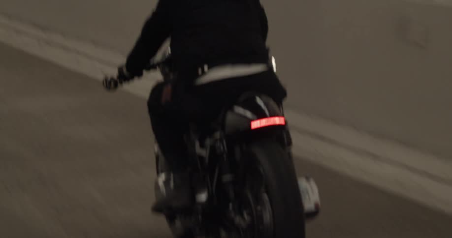 A motorcyclist drives through a tunnel