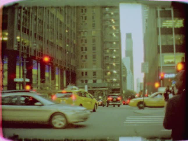 Cars drive on a busy city street