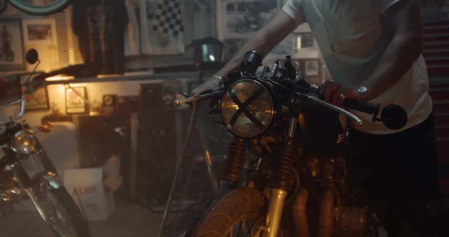 The man turns on the light on his motorcycle