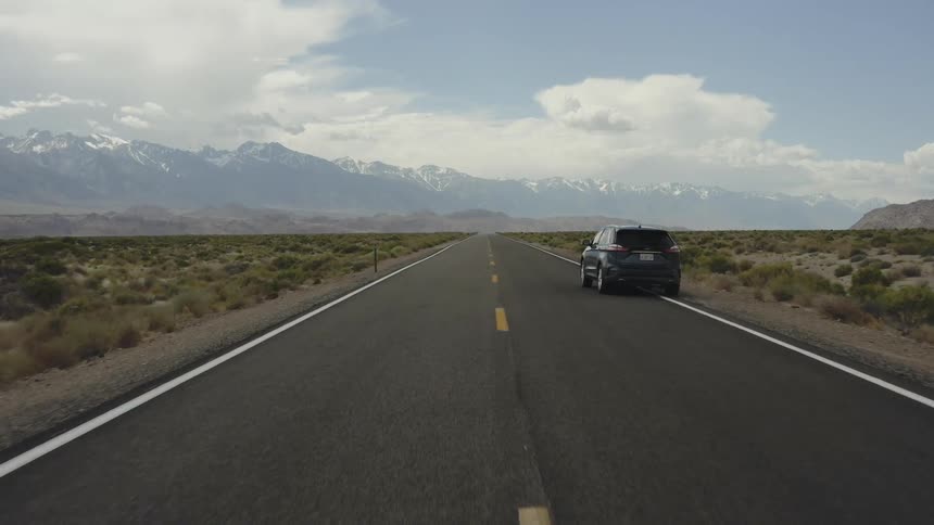 A car drives on a rural road