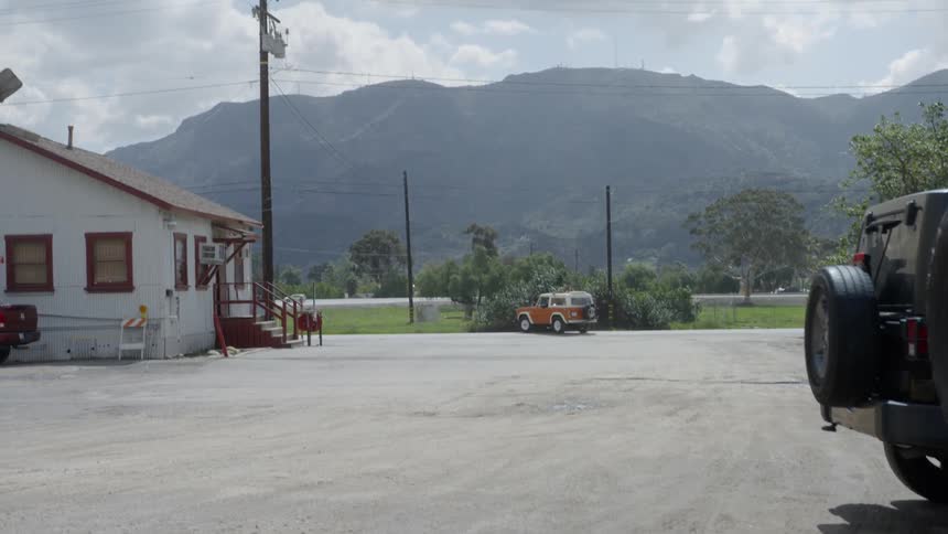 The cars travel past the road near the mountain