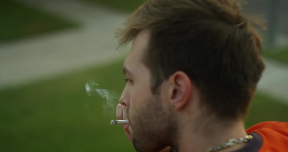 A man is smoking a cigarette