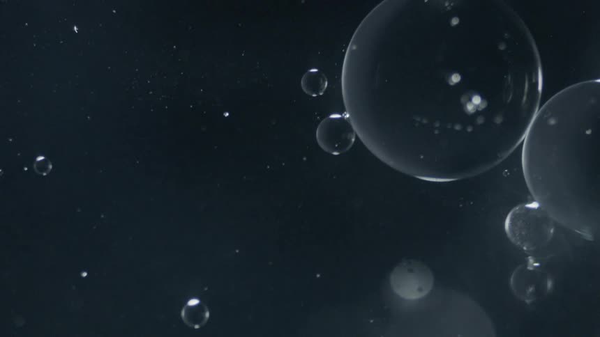 Bubbles are floating in dark liquid