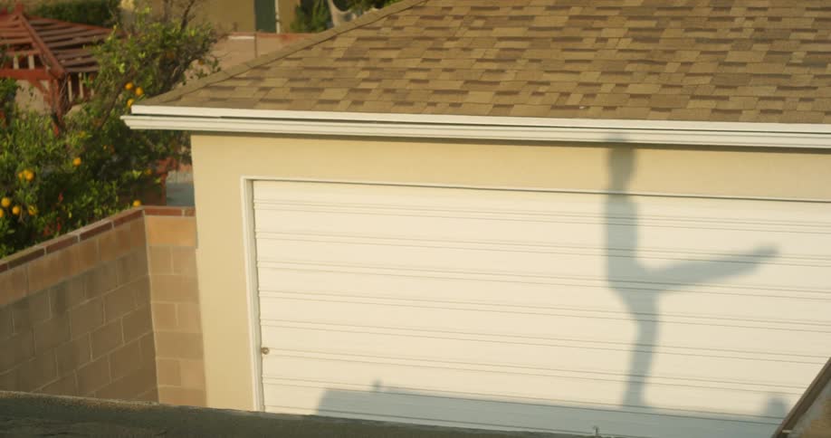 Person dances on top of a roof