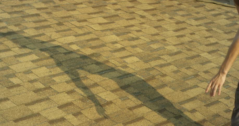 A man dances on a rooftop