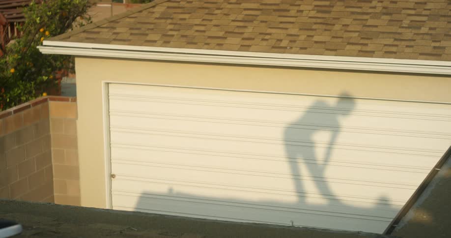 Woman bends over and stretches near a garage door