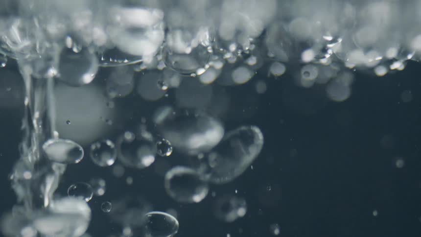 Bubbles float to the top as liquid streams in