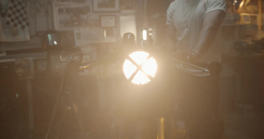 Man Working On Motorcycle In Garage