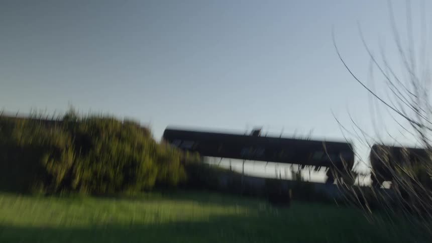 The train is moving on the green hill above