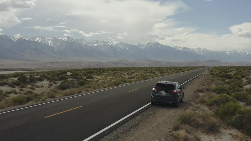 A car is pulled over on the side of a rural road