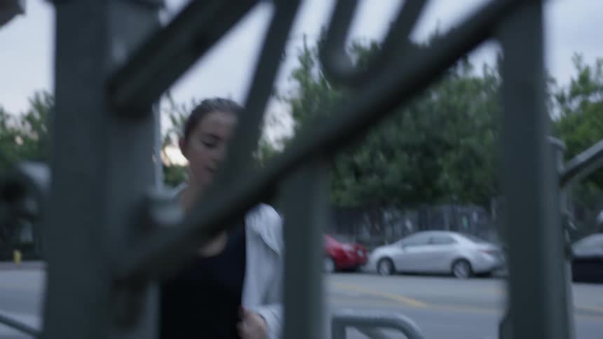 The woman runs over to the steps climbing up