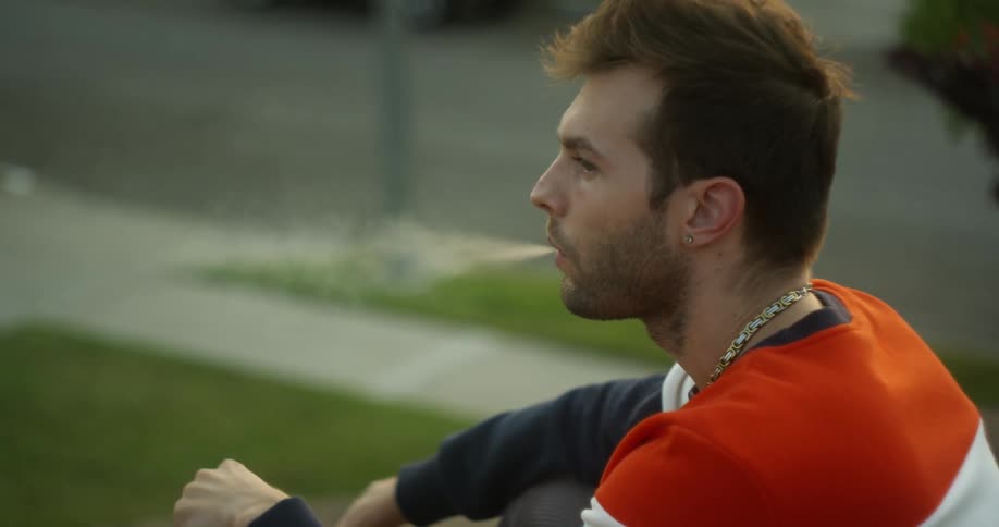 A man smokes a cigarette outside