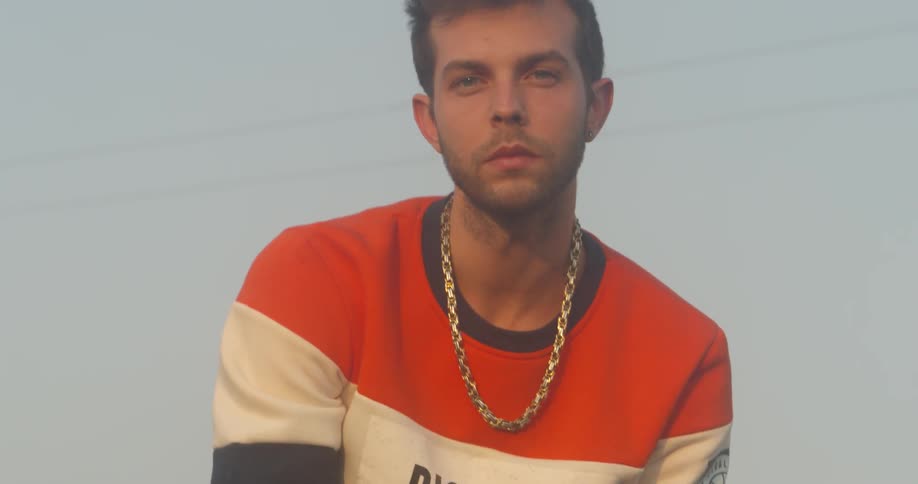 The man is wearing a gold necklace