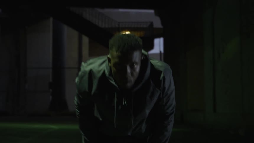 A man bends with hands on knees trying to catch his breath