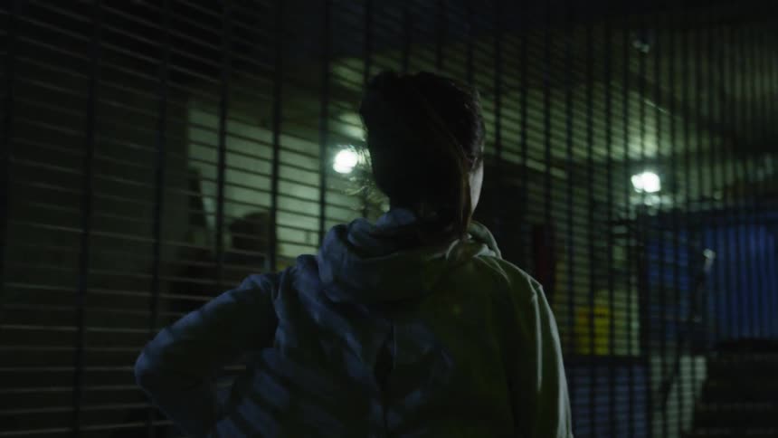 A woman is jogging outside at night