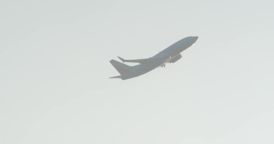 An airplane gains altitude