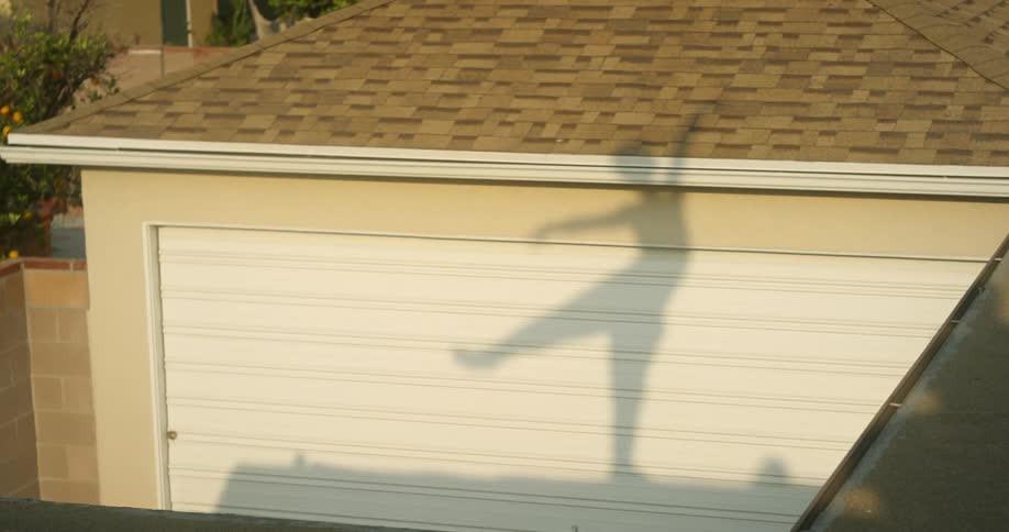 The person makes a shadow balancing on the roof