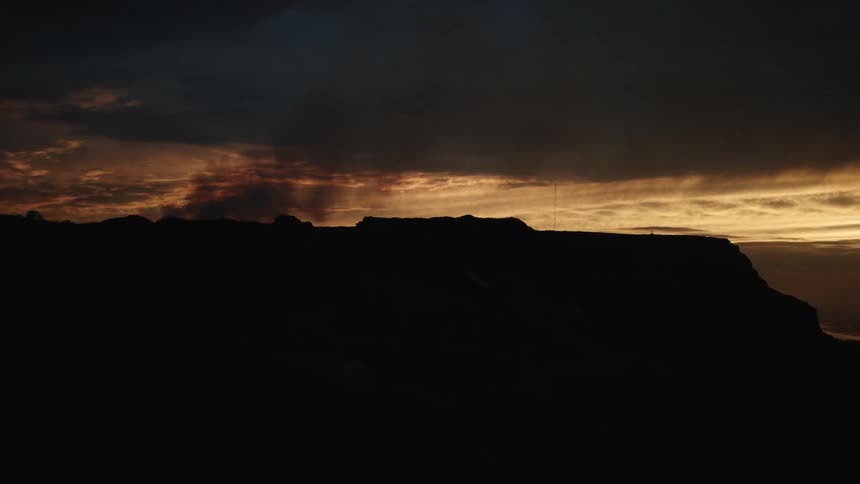 The sun is nearly set over the mountains
