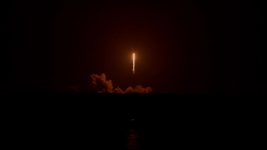 A shuttle lifts off at night