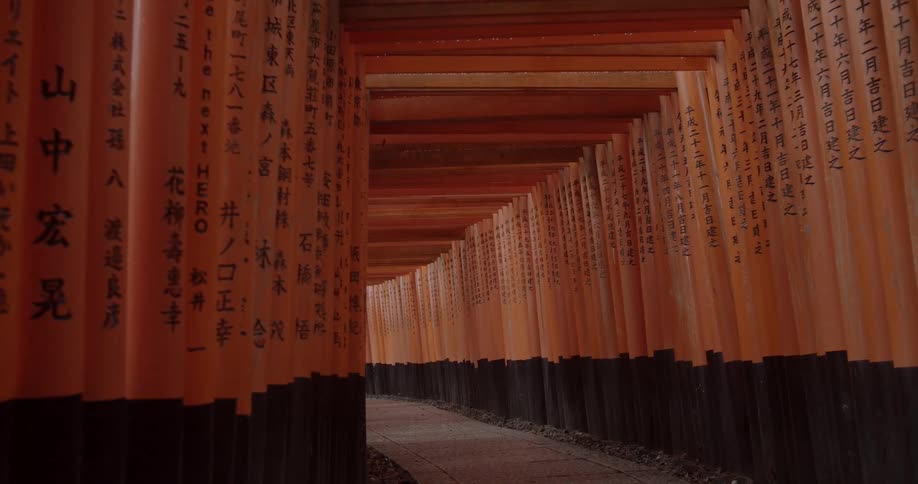 A lantern hangs in a red tunnel in asia
