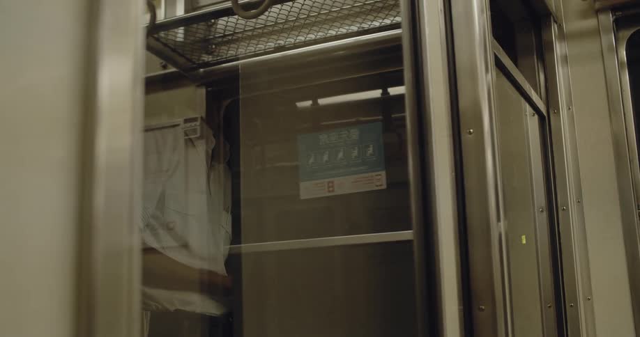 A man rides on a subway train