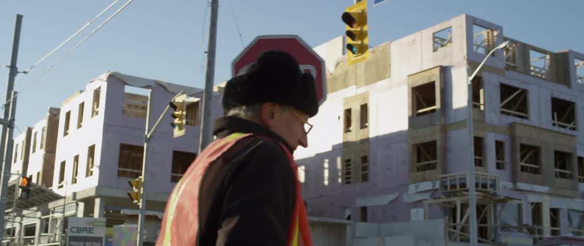 A crossing guard carries a stop sign