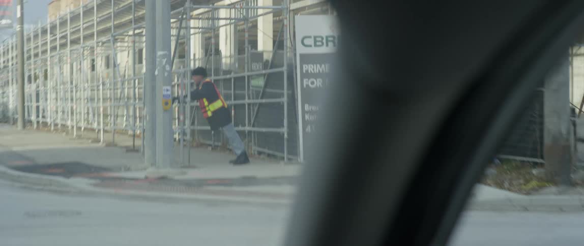 Man wearing a vest pushes against a railing