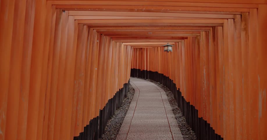 A lantern hangs in a red tunnel