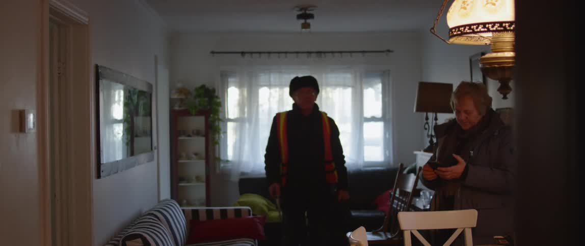A traffic guard picks up a stop sign at home before leaving for work