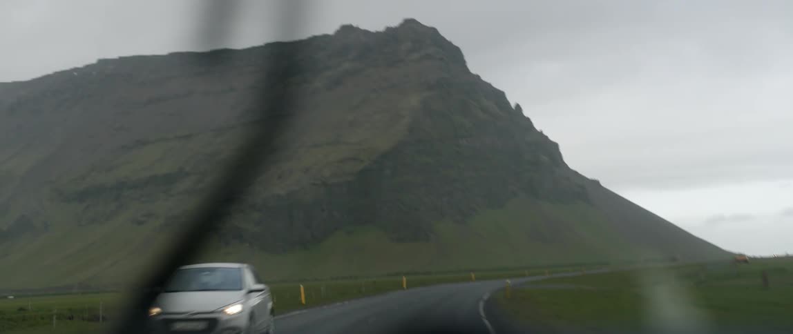 Vehicles ride on a mountain road