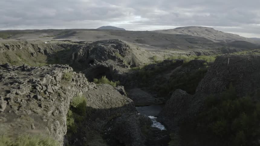 Grey clouds hang above the canyons