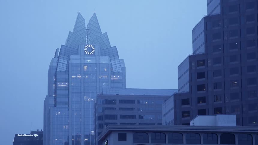 City building lights glow at dusk
