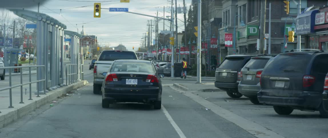 Cars travel on a city street