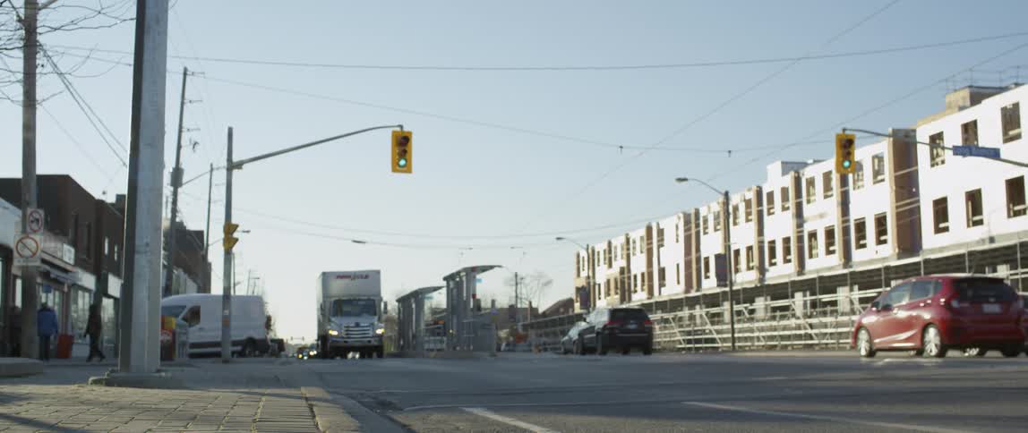 The vehicles travel down the street