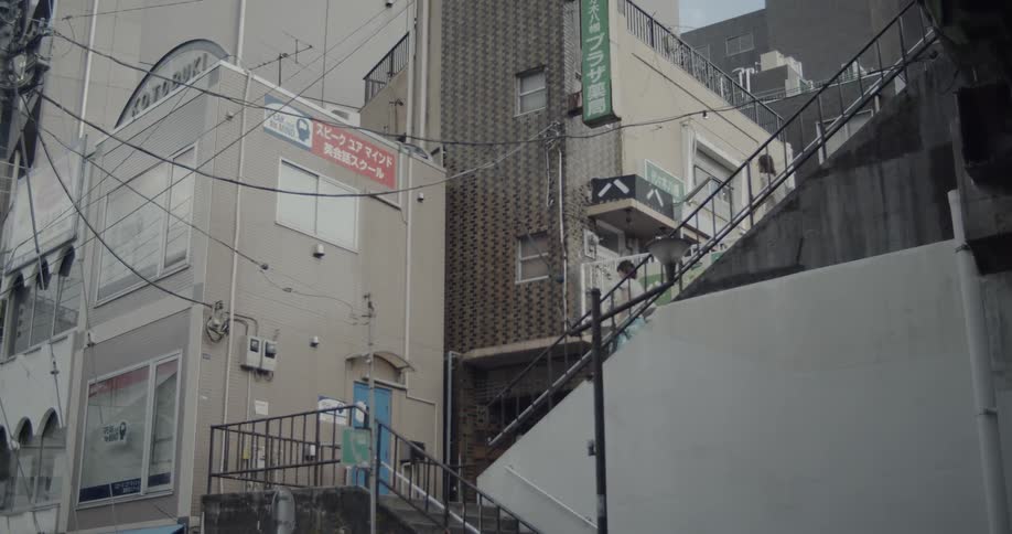 Two people descend down the stairs