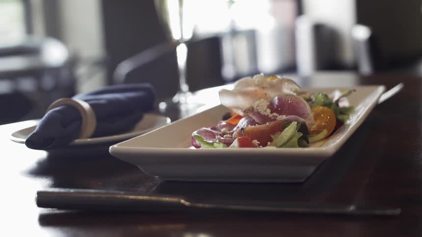 Food sits in a rectangular plate on the table