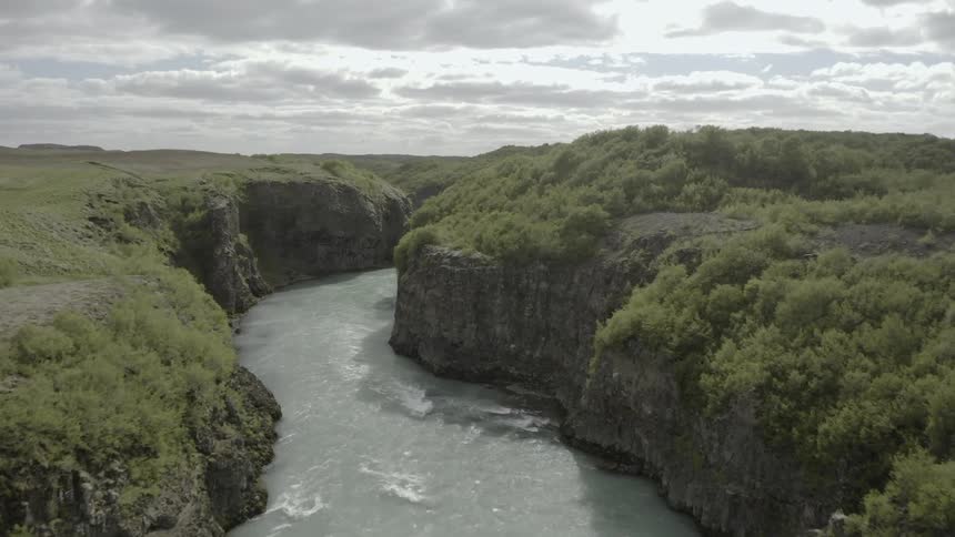River flows in between the hills on each side
