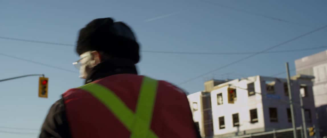 A crossing guard carries a stop sign