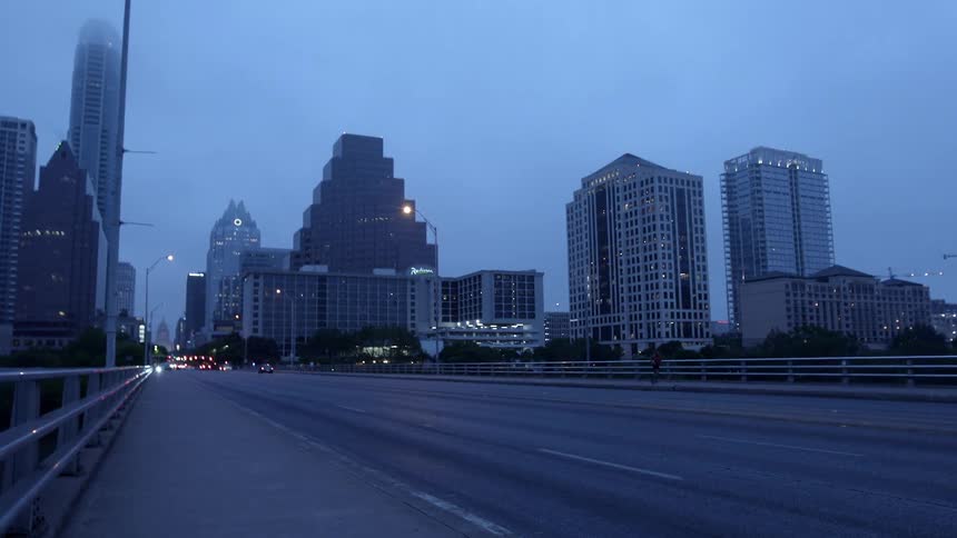 Car traveling on city freeway at dusk