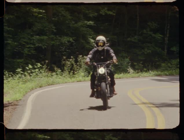 A motorcycle is driven on a rural road