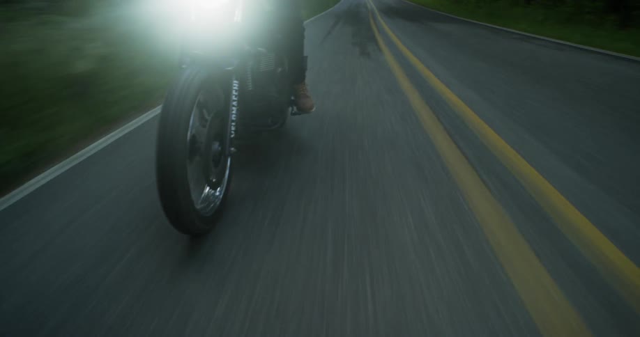 A motorcycle is driven on a rural road