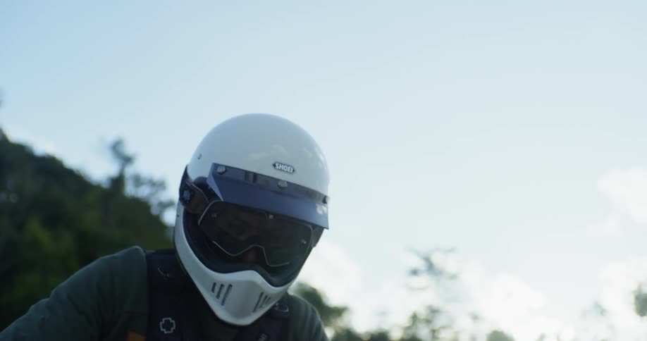 A motorcyclist rides in mountains